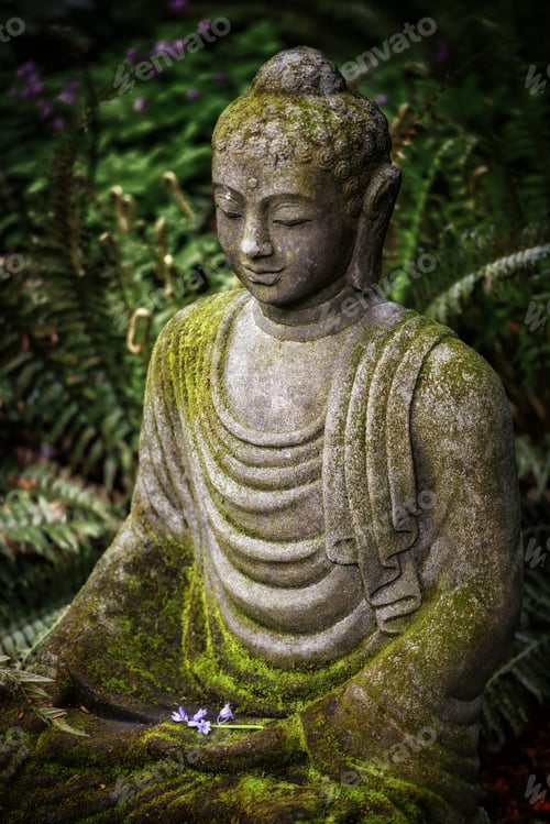 Preview: Vertical shot of a Buddha statue with moss on top and greenery on the background