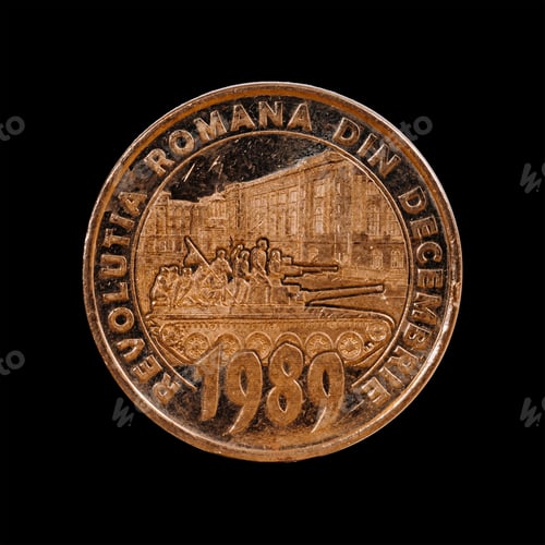 Preview: View of a Romanian fifty bani coin isolated on a black background