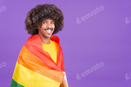 Preview: Happy african man wrapped with a lgbt flag