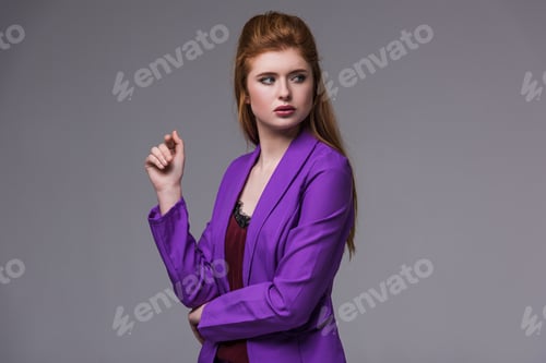 Preview: Young female fashion model in jacket isolated on grey