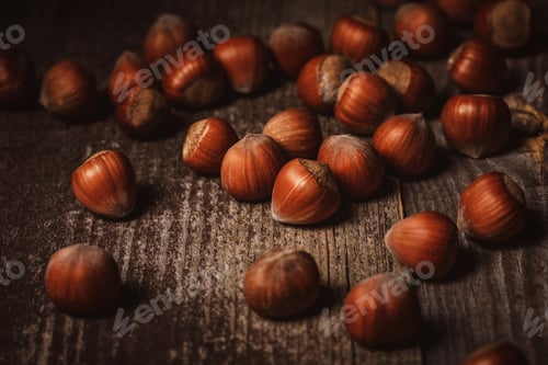 Preview: close up view of shelled hazelnuts on wooden backdrop