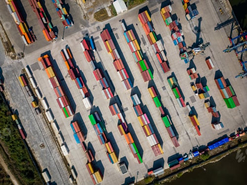 Preview: aerial view of a container terminal at the port, where massive containers await their journey