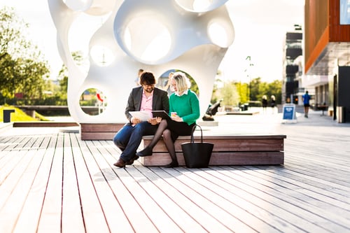 Preview: Full length of businessman with female colleague discussing at Malmo Live