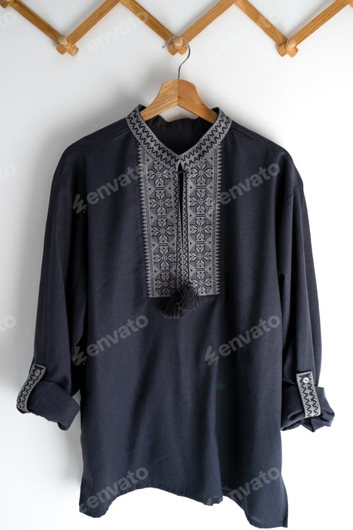 Preview: Ukrainian clothes embroidered man shirt. Blue gray and black threads background. Vyshyvanka is a