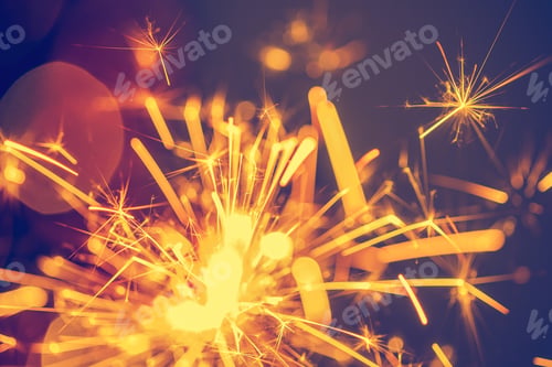 Preview: Close-up of holiday Christmas sparkler on dark background