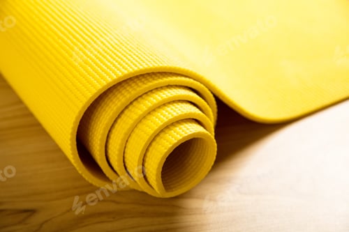 Preview: Close-up of yellow fitness mat on the floor
