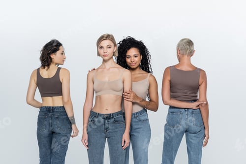 Preview: Multiethnic women in tops posing on grey background