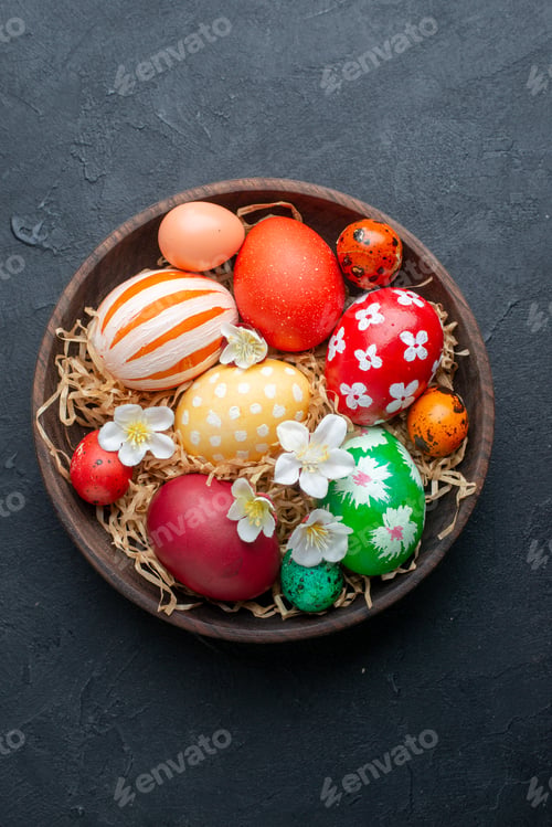 Preview: top view colored designed eggs inside brown plate dark background novruz holiday spring ornate