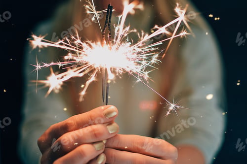 Preview: Midsection of woman holding sparkler