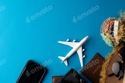 Preview: Airplane model, sunglasses, passport, camera and smartphone on blue background with copy space