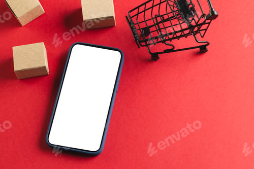 Preview: Smartphone with copy space and trolley with boxes on red background