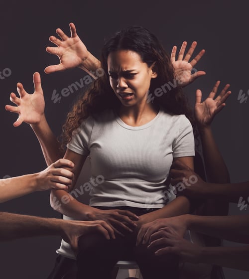 Preview: Trauma is hell on earth. Shot of hands grabbing a young womans against a dark background.