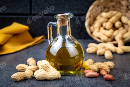 Preview: Peanut oil in glass bottle and peanuts