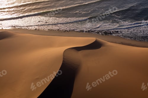 Preview: Aerial view of the dune and waves meeting on the coast of Namibia
