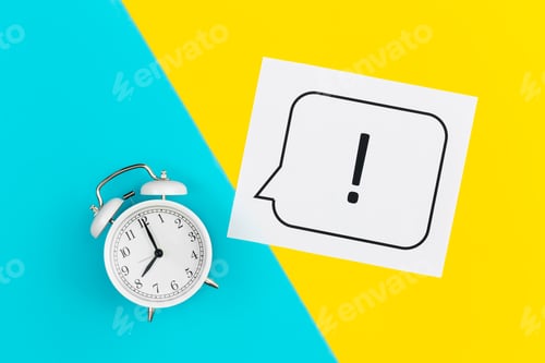 Preview: Alarm clock and exclamation mark on yellow and blue background, flat lay.
