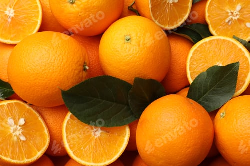 Preview: Juicy oranges and green leaves as background, top view