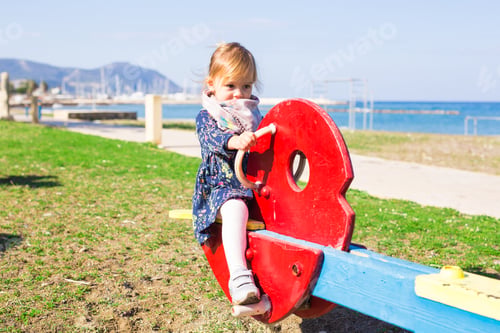 Preview: Active little girl on playground