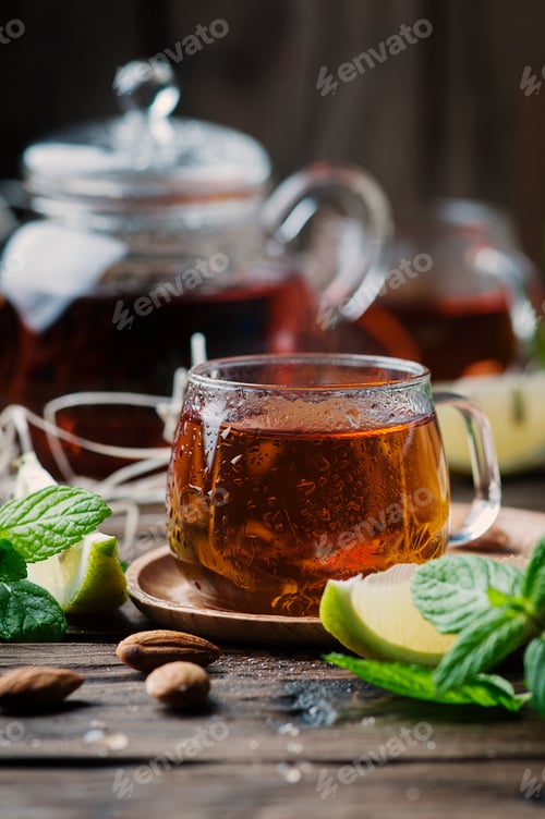 Preview: Hot black tea with lemon and mint on the wooden table