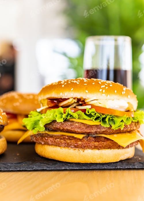 Preview: Assorted of classic american burger on black stone board and cola in the interior of the cafe.