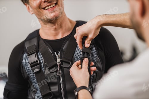 Preview: Fitness Instructor Putting An Ems Suit To A Man