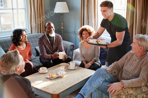 Preview: Waiter Serving Group Of Mature Friends In Coffee Shop