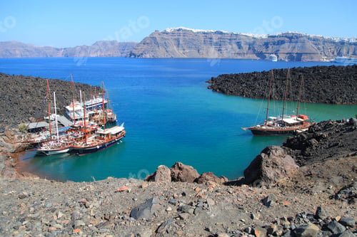 Preview: Tourist excursion boats at small port on volcano of Santorini