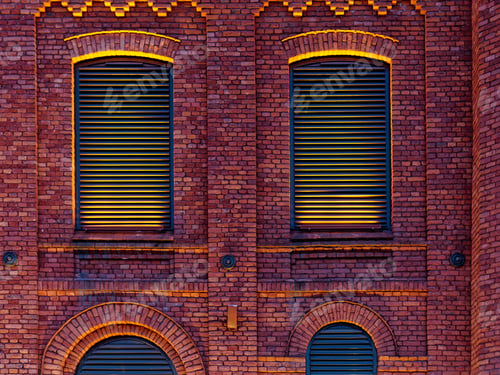 Preview: illuminated red brick building wall night time