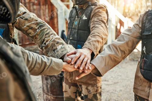 Preview: Paintball, team and hands together for meeting in huddle, motivation or game plan on the battle fie