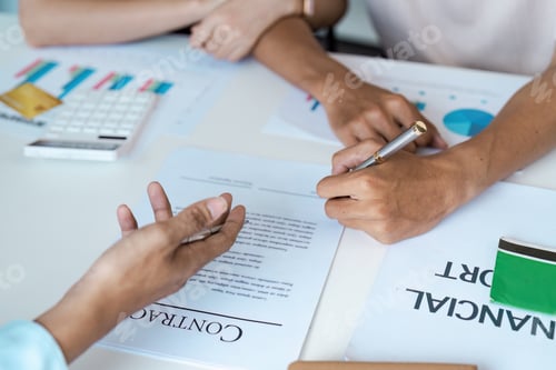Preview: Business Meeting with Financial Reports and Contract Signing in Modern Office Setting