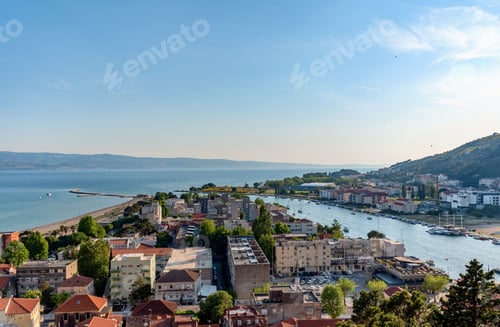 Preview: Aerial view of cityscape Omis surrounded by buildings and Cetina river