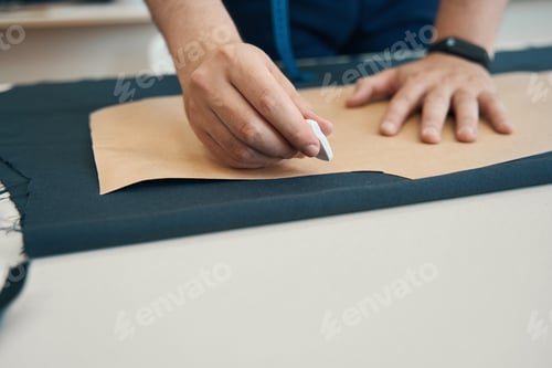 Preview: Pattern lies on piece of dark fabric and is pressed by hand