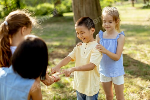 Preview: Group of asian and caucasian kids having fun in the park