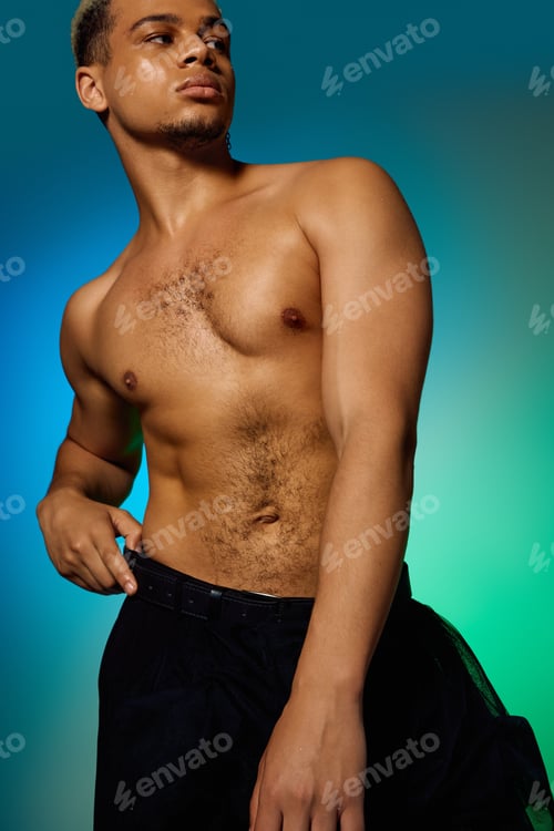 Preview: Young man with dyed hair showcases his style in a vibrant studio setting