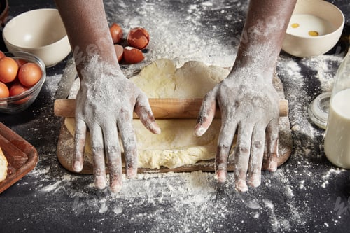 Preview: Cropped shot of male`s hands rolls out paste with rolling pin, uses necessary ingredients for making