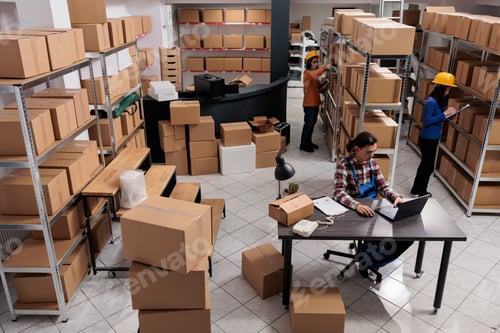 Preview: Asian postal service team doing inventory in industrial warehouse
