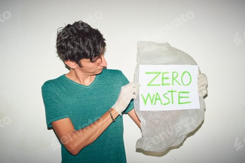 Preview: Young man holding plastic bag with "Zero Waste" sign
