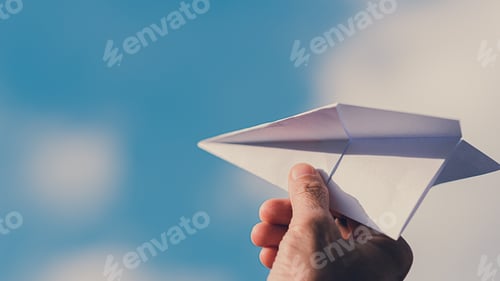 Preview: Man's hand holding paper plane, Blue sky background with natural light.