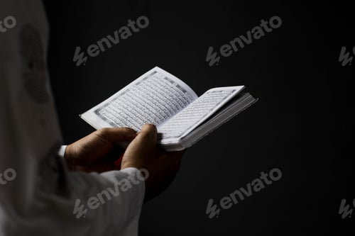 Preview: Muslim hands holding Quran