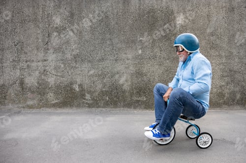 Preview: Funny businessman driving retro trike outdoor