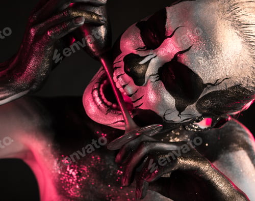 Preview: Pretty girl with skeleton makeup holds glass