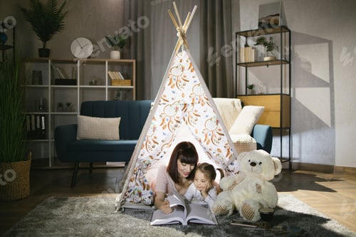Preview: Mother reading daughter evening stories in wigwam