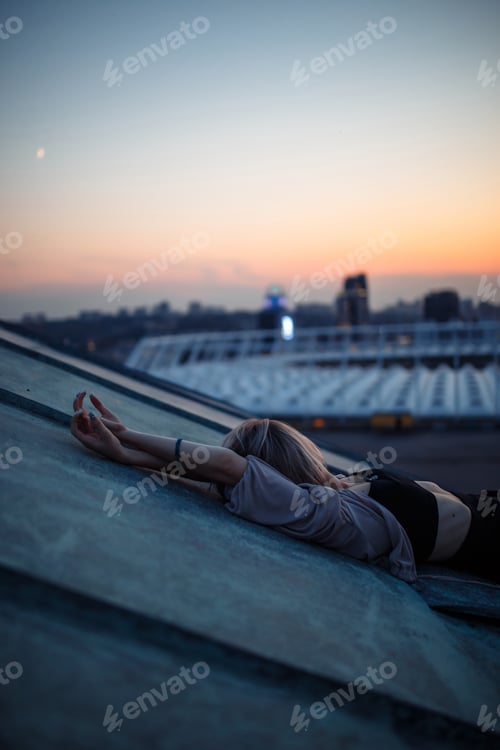 Preview: Young woman in roof enjoying sunset, freedom city atmosphere. People, lifestyle, relaxation concept.