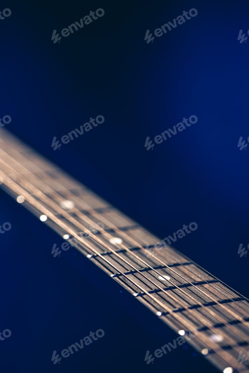 Preview: Part of an acoustic guitar, guitar fretboard on a black background.