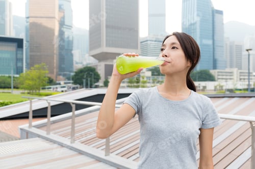 Preview: Sport Woman drink with green beverage at outdoor