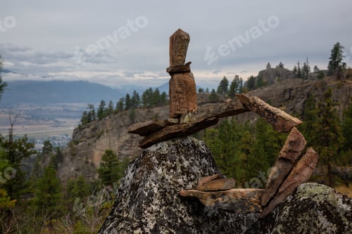 Preview: Stack of balancing rocks in nature during a cloudy summer morning