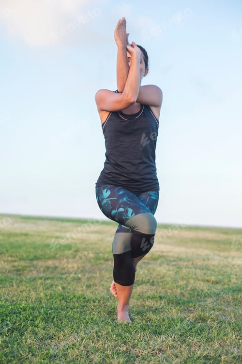Preview: A Young woman doing yoga exercise outdoor