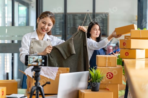 Preview: Startup small business SME. Beautiful asian entrepreneur using camera live streaming online chat wit