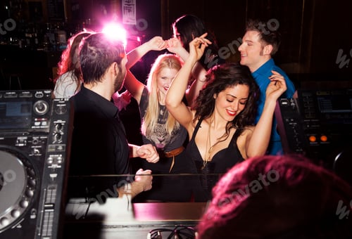 Preview: Group of friends dancing in front of DJ in nightclub