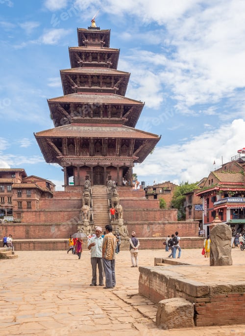 Preview: NEPAL, KATHMANDU - AUGUST 4, 2014: Street with people near amazing high temple and blue sky