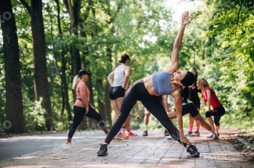 Preview: Stretching exercise by woman. Group of runners are together outdoors